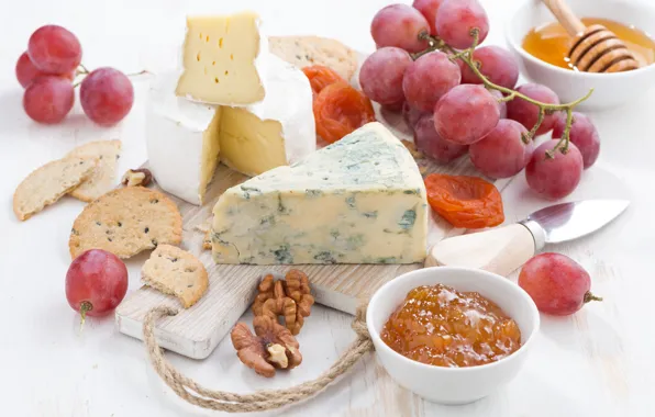 Picture cheese, grapes, nuts, jam, dried apricots